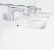 Row of faucets and basins in commercial bathroom